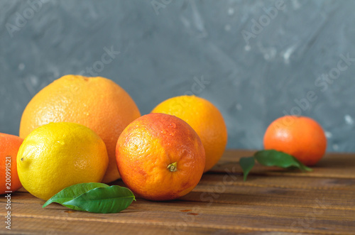 Fresh citrus fruits on wooden table. © Maksim
