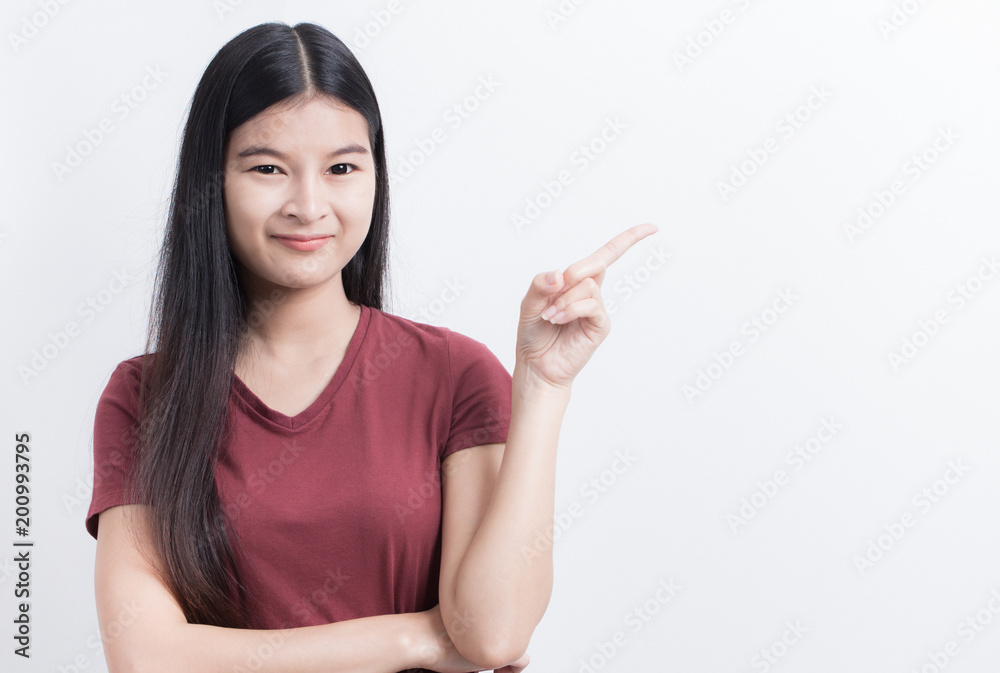 Asian woman is pointing fingers at empty white background for editing. Asian woman is pointing fingers at empty white background for editing.
