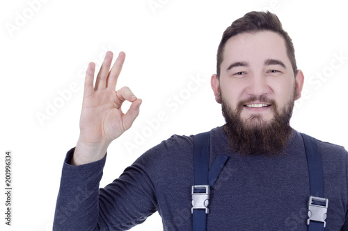 Young man with a beard in overalls © Art of Success