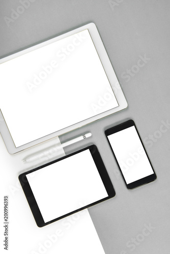 Office table with digital tablet, smartphone, pencil on isolated pure white background. Laptop and tablet mockup concept. (Monitor clipping path)(Selective Focus)