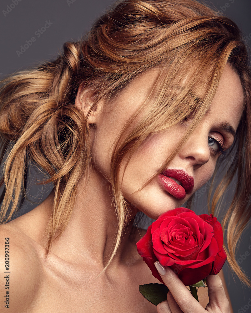 AI generated young woman posing looking at pink rose and smelling it  35821102 Stock Photo at Vecteezy