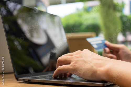Man hands using laptop and holding credit card with and using laptop computer as Online shopping concept, selective focus