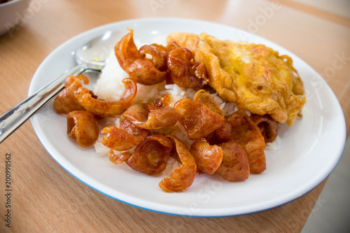 Chinese sausages and omelet topping on rice.