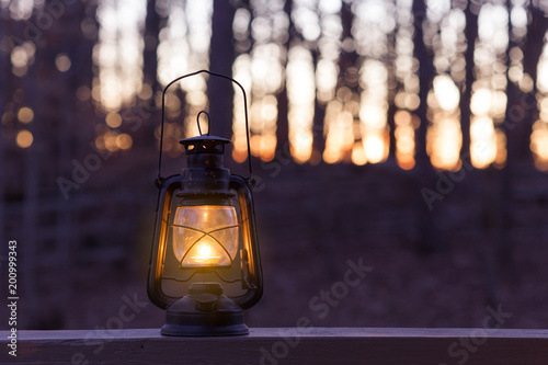 Old fashioned lantern in darkness photo