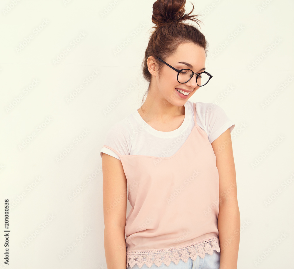 Portrait of young beautiful brunette woman girl model with nude makeup in colorful summer pink hipster clothes posing near wall. Going crazy Portrait of young beautiful brunette woman girl model with nude makeup in colorful summer pink hipster clothes posing near wall. Going crazy