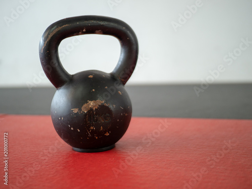 Fototapeta Naklejka Na Ścianę i Meble -  10 kg kettle bell sitting on gym mat