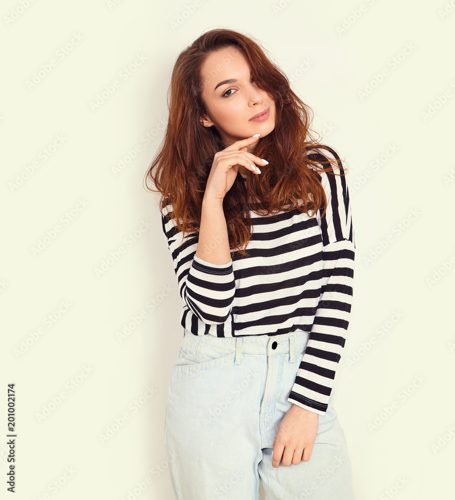 Portrait of young beautiful brunette woman girl model with nude makeup in summer hipster clothes posing near wall. Going crazy Portrait of young beautiful brunette woman girl model with nude makeup in summer hipster clothes posing near wall. Going crazy