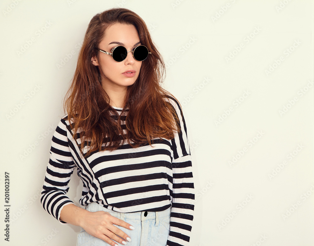 Portrait of young beautiful brunette woman girl model with nude makeup in summer hipster clothes posing near wall. Going crazy Portrait of young beautiful brunette woman girl model with nude makeup in summer hipster clothes posing near wall. Going crazy