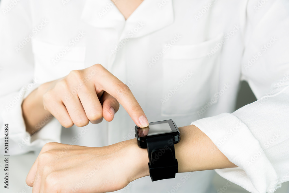 Woman touch screen digital clock in the display and technology advances in communication. This is a new technology. That makes life more comfortable. Woman touch screen digital clock in the display and technology advances in communication. This is a new technology. That makes life more comfortable.