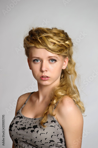 portrait of a blonde with a creative hairstyle with braids  studio