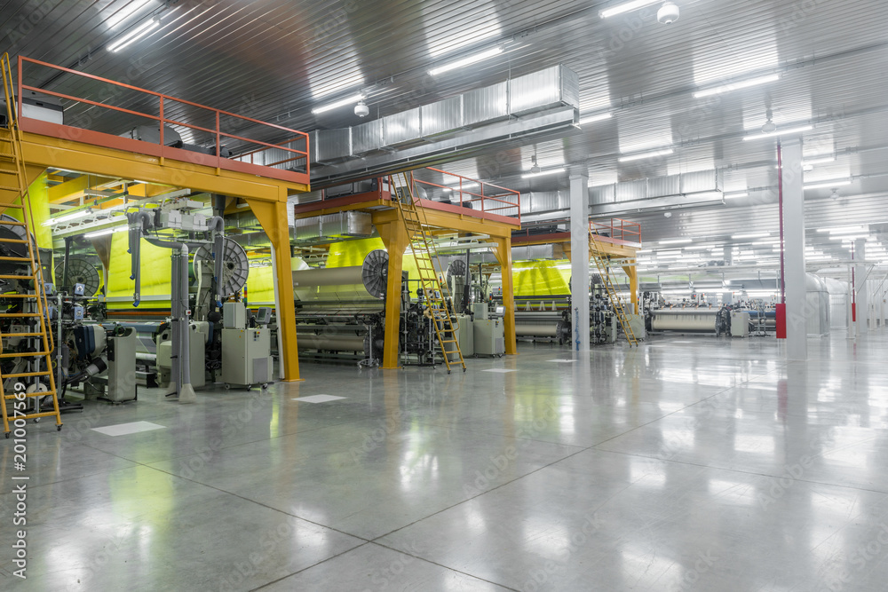Machine and equipment in the weaving shop, a general overview. interior of industrial textile factory Machine and equipment in the weaving shop, a general overview. interior of industrial textile factory