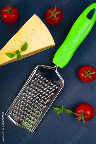 Cheese, cherry tomatoes, basil and grater