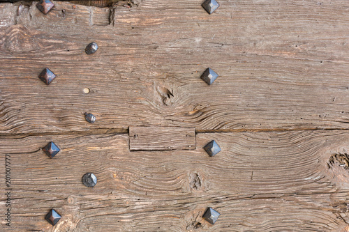 old wooden door with iron forged rivets photo