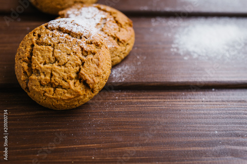Canvas Print Oatmeal cookies on a wooden table in castor sugar, copy space