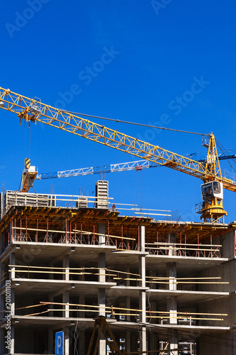 construction of a multi-storey building on a blue sky background