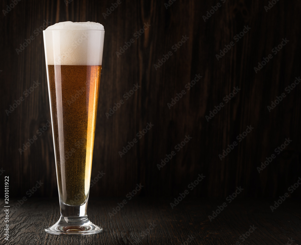 Glass beer on wood background