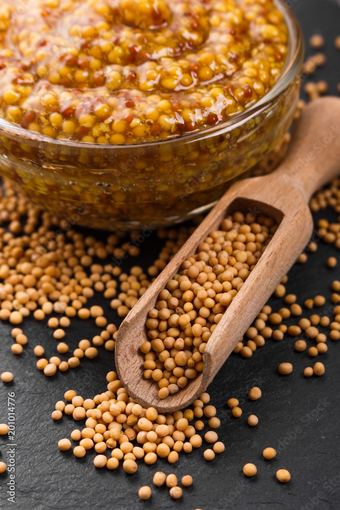 mustard in a bowl on a rustic background mustard in a bowl on a rustic background