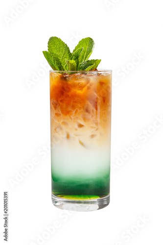 A multicolored, three-layered opaque cocktail in a tall glass with crushed ice and mint leaves and coffee beans, with the taste of menthol, coffee, caramel, cream. Side view. Isolated white background
