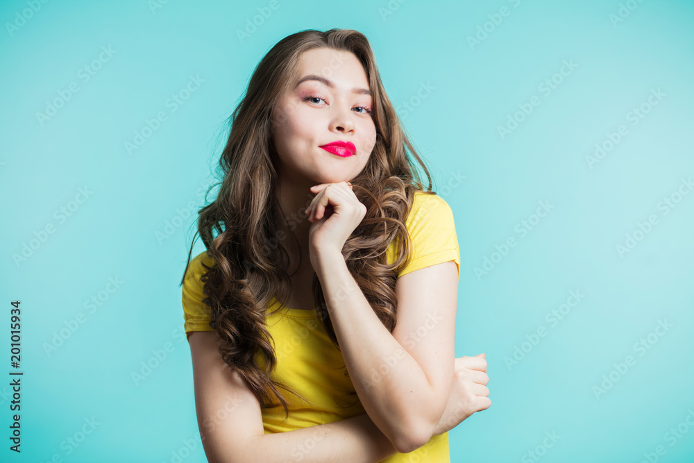 Beautiful girl in a good mood watching with a smile, a smirk in the camera. Positive emotions Beautiful girl in a good mood watching with a smile, a smirk in the camera. Positive emotions