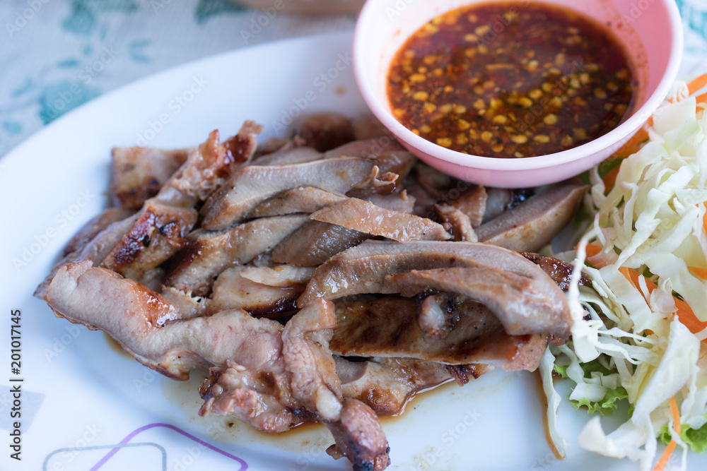 Grilled pork with chilli sauce close up shot