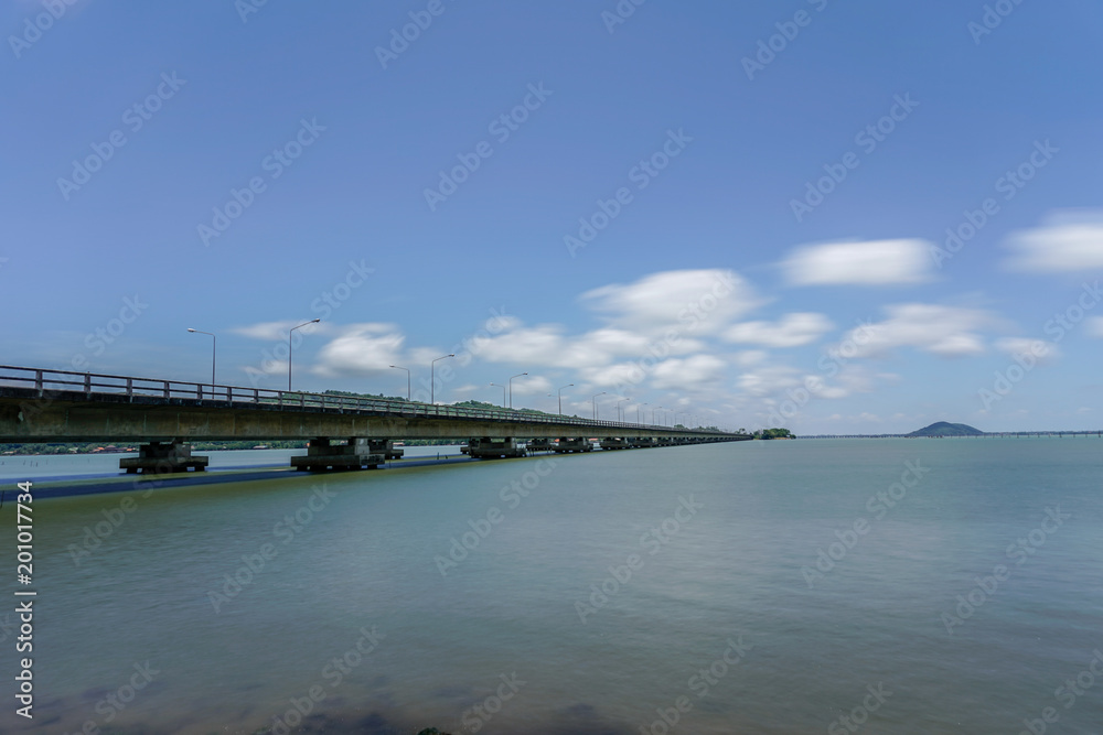Tinsulanonda bridge with smooth cloud and sea in broad daylight
