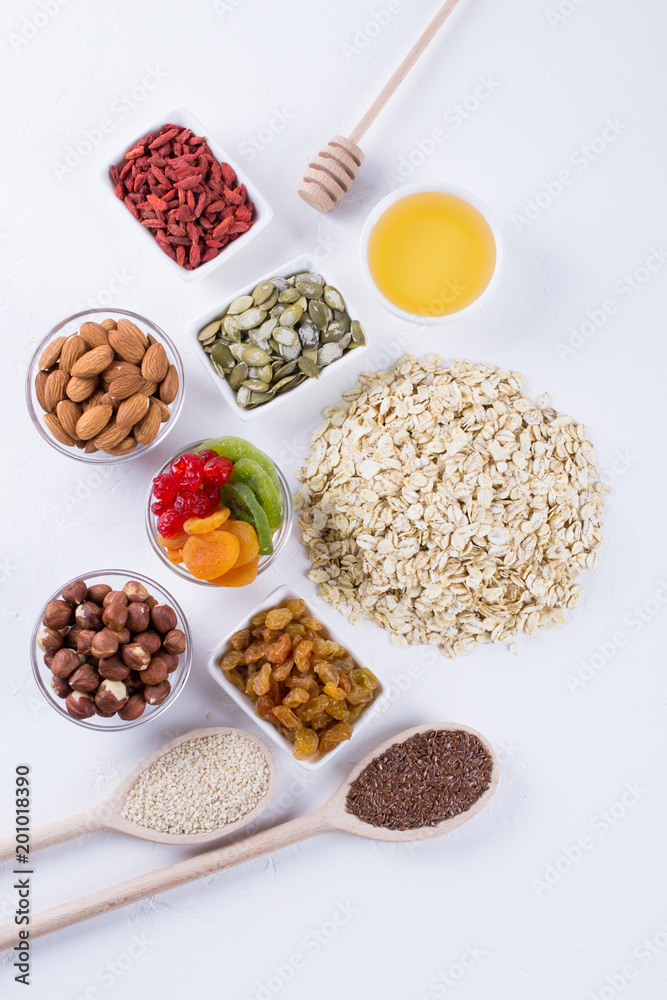 Ingredients for homemade oatmeal granola. Oat flakes, honey, nuts, dried fruit and seeds. Healthy breakfast concept. Ingredients for homemade oatmeal granola. Oat flakes, honey, nuts, dried fruit and seeds. Healthy breakfast concept.