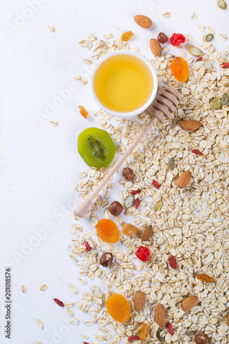Fototapeta Naklejka Na Ścianę i Meble -  Oat flakes and various delicious ingredients for healthy breakfast, top view,