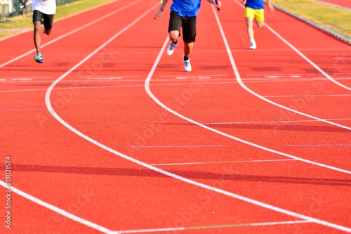 Athletes at the end of a red track speed race © liberowolf