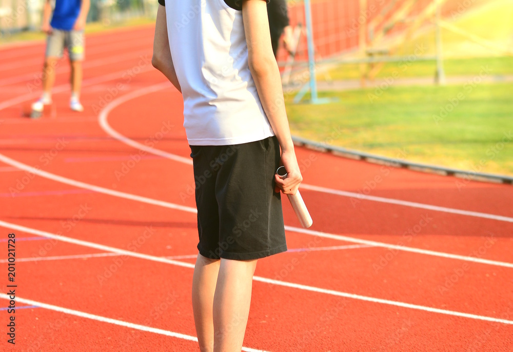 Fototapeta premium Athlete in the starting blocks for a relay race.
