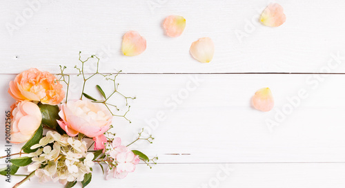 Festive flower composition on the white wooden background. Overhead view