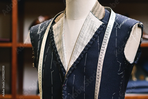 Tablou pe pânză Close up of a suit hanging on hanging clothes, just made to measure by a tailo
