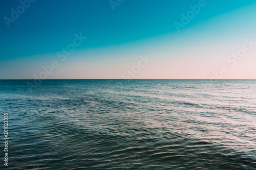 Sunny Blue Clear Sky Over Calm Water Of Sea Or Ocean. Natural Seascape