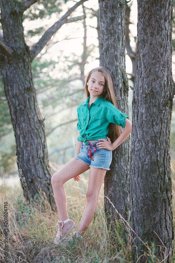 Little cute girl spends his free time outdoors in the woods. Little cute girl spends his free time outdoors in the woods.