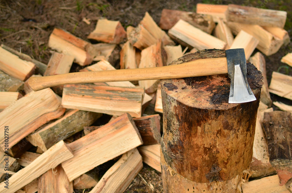 Ax against the background of chipped firewood Ax against the background of chipped firewood
