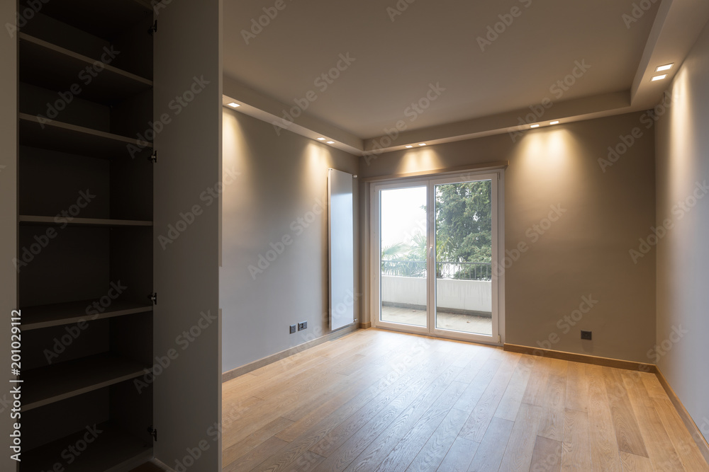 Fototapeta premium Modern room with wardrobe, balcony overlooking nature.