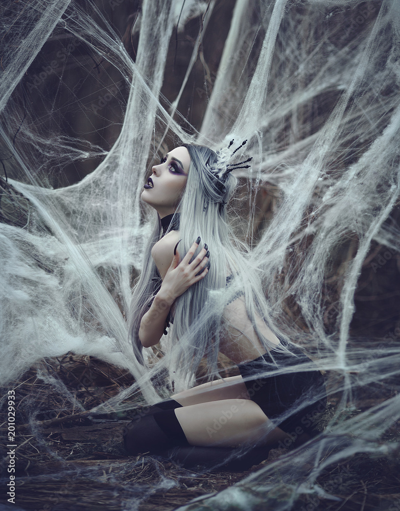 Beautiful sexy Gothic girl with pale skin and long white hair like spider  black widow in