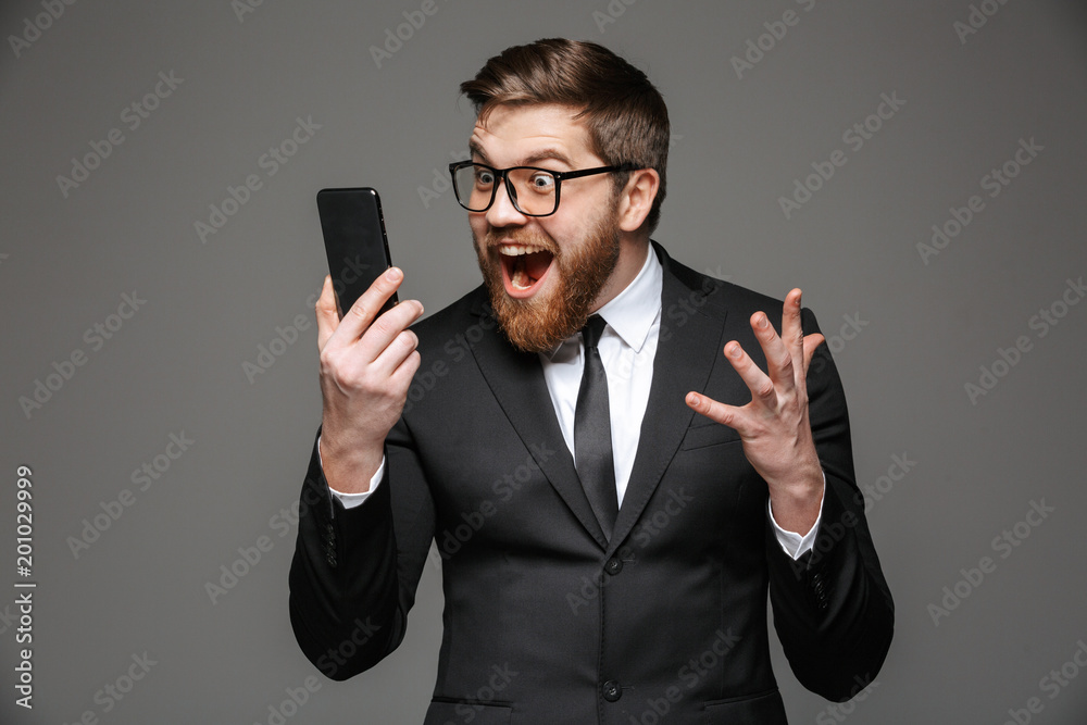 Portrait of an excited young businessman dressed in suit Portrait of an excited young businessman dressed in suit