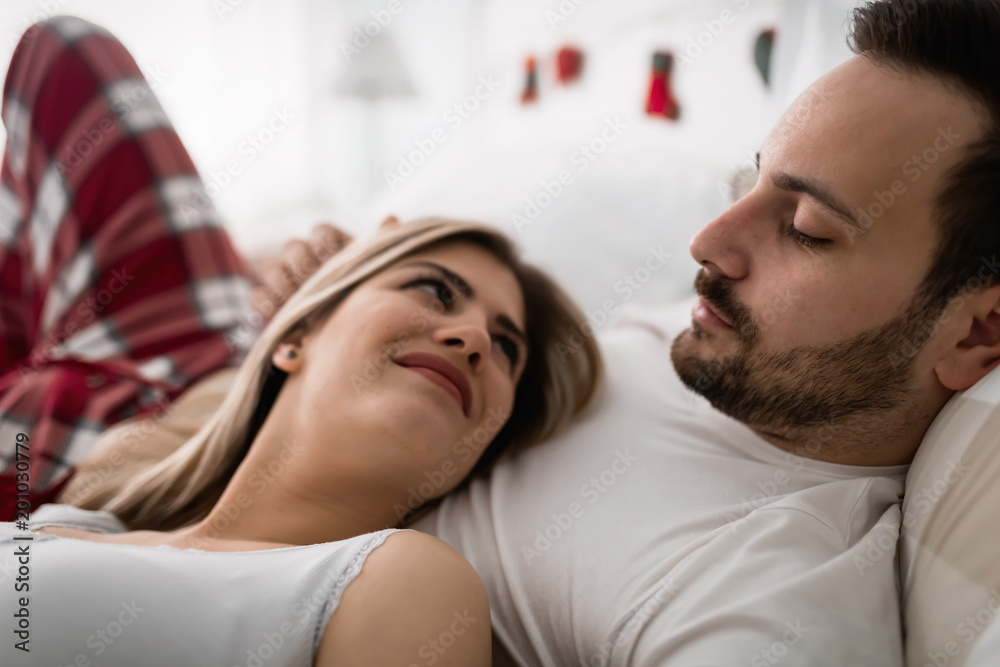 Young attractive couple having romantic time in bed Young attractive couple having romantic time in bed
