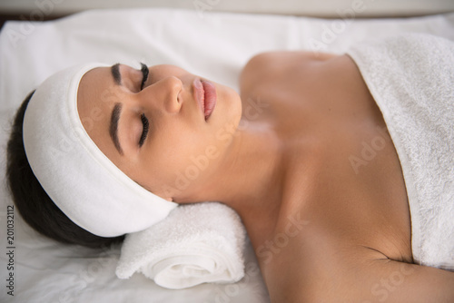 Spa recreation. Nice young woman closing her eyes while enjoying spa recreation