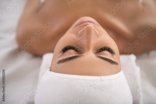 Absolutely relaxed. Face of a pleasant nice relaxed woman enjoying spa salon procedure