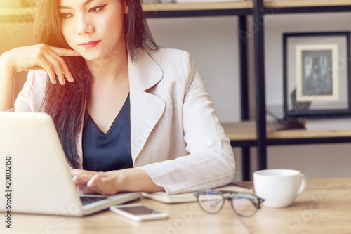 young Asian business woman at work. beautiful Asian woman in casual suit working with computer laptop in modern office. freelance and start up business in Asia concept