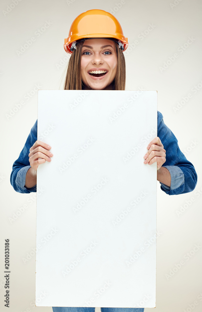 Woman builder holding white advertising banner, billboard, sign Woman builder holding white advertising banner, billboard, sign