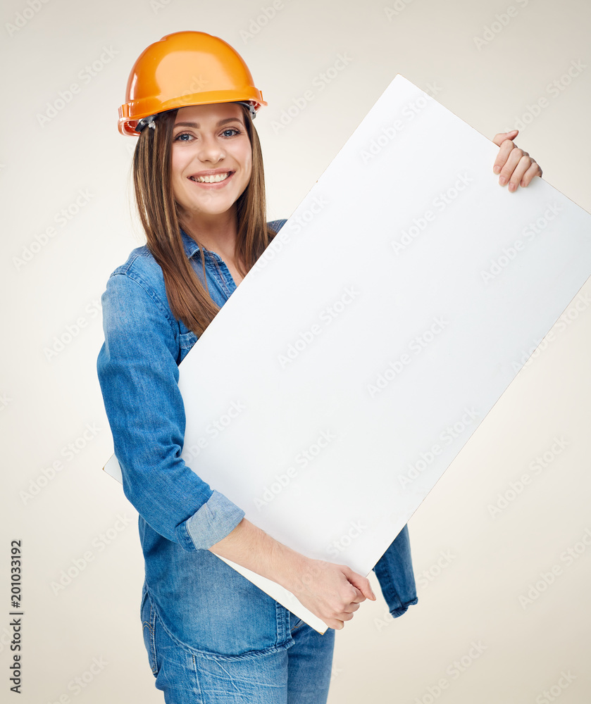 Woman builder holding white advertising banner, billboard, sign