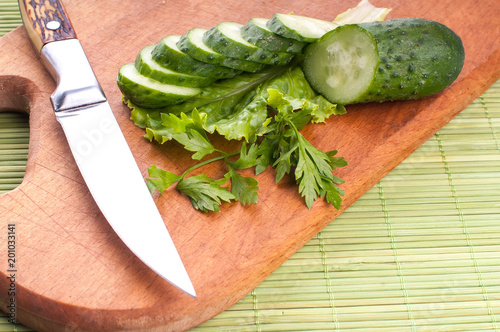 Fresh and sliced cucumbers. Sliced cucumbers on a cutting board. cucumbers for diet and healthy eating. photo