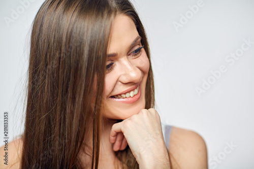 Beautiful smiling woman looking side. Close up face portrait.