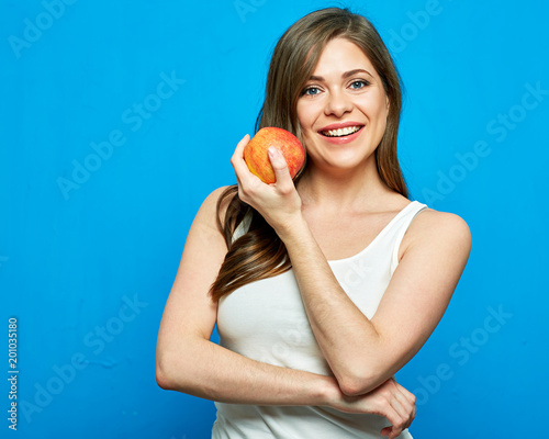 Smiling woman holding red apple. Toothy smile.