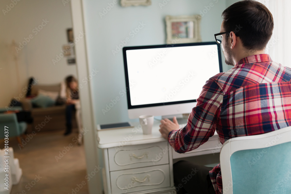 Young handsome designer working on project on computer Young handsome designer working on project on computer