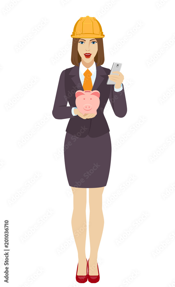 Businesswoman in construction helmet using a mobile phone and holding a piggy bank Businesswoman in construction helmet using a mobile phone and holding a piggy bank