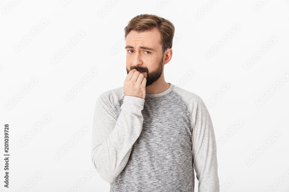 Confused young man isolated over white wall Confused young man isolated over white wall