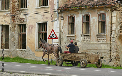 Romania, horse-drawn vehicle in front of a ruinous house